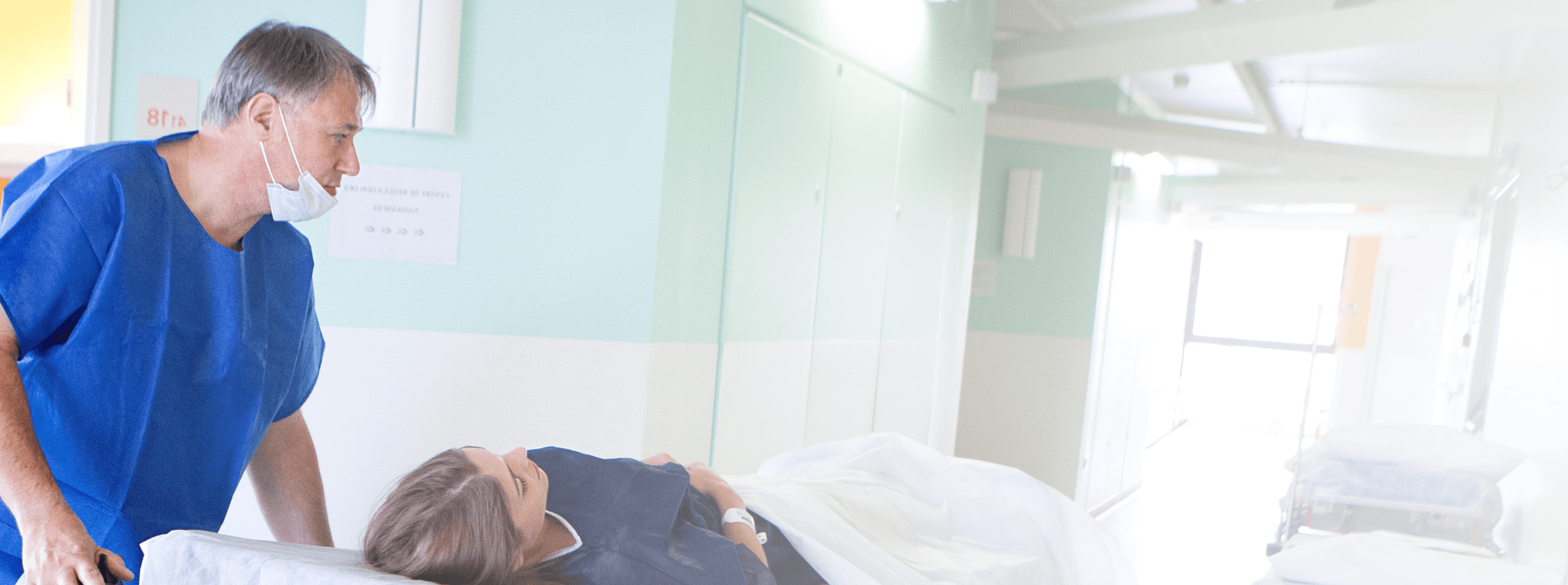 Group 6655 Photo of a medical professional transporting a patient on a hospital bed