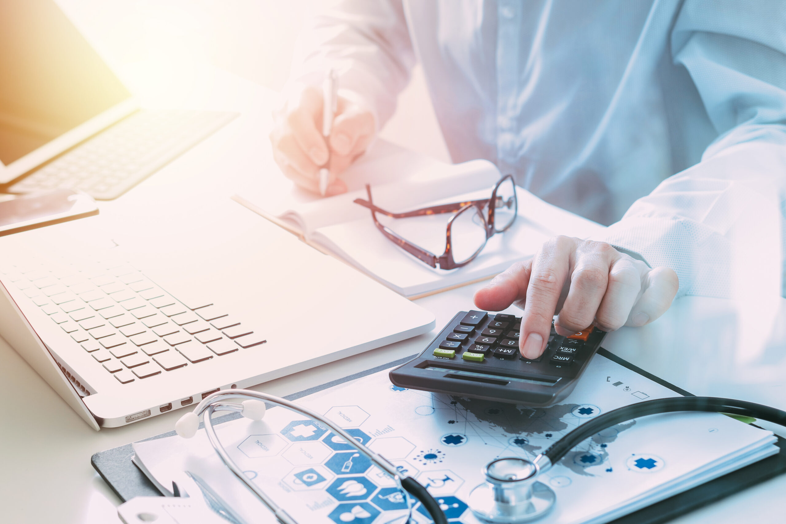 Coronis Health stock photo of businessperson using a calculator