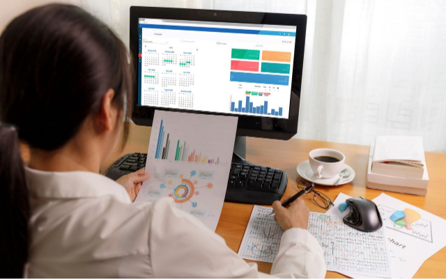 coronis health woman on a computer for page about medical billing services for ophthalmology