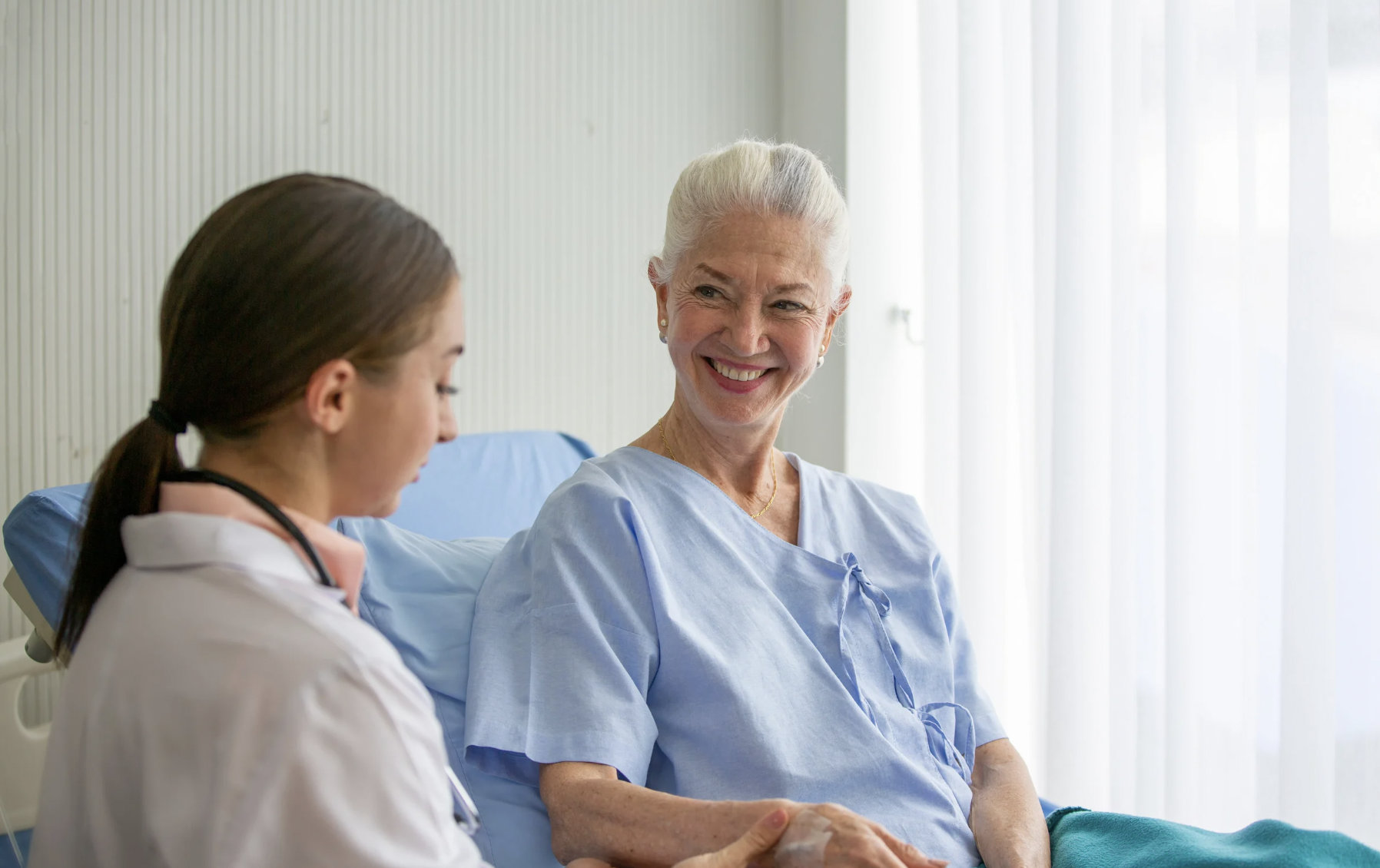 coronis health hospital worker consulting patient