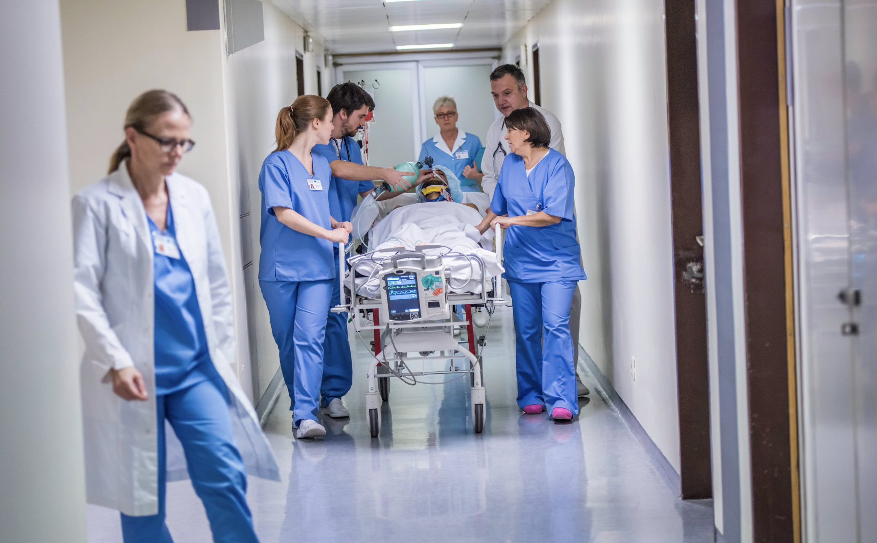 coronis health rural hospital staff transporting patient in stretcher