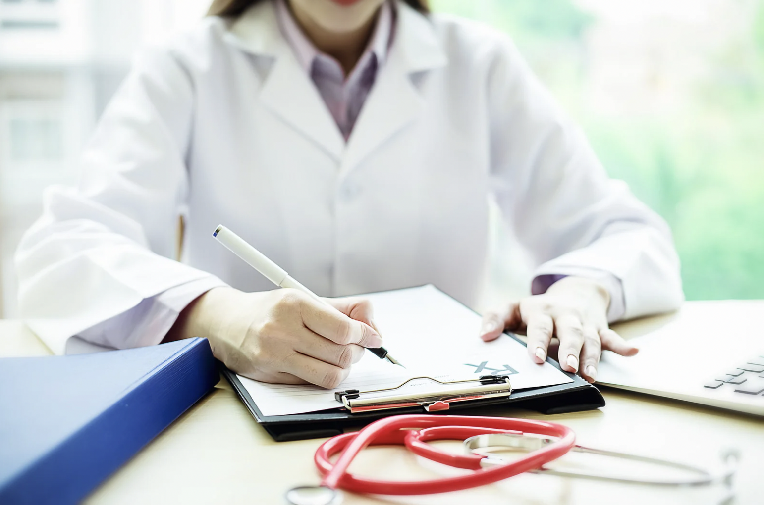 coronis health hospital revenue cycle management professional writing on clipboard