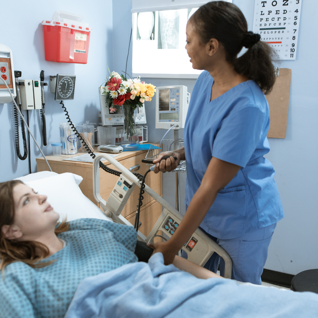 coronis health nurse in a hospital taking patient's blood pressure