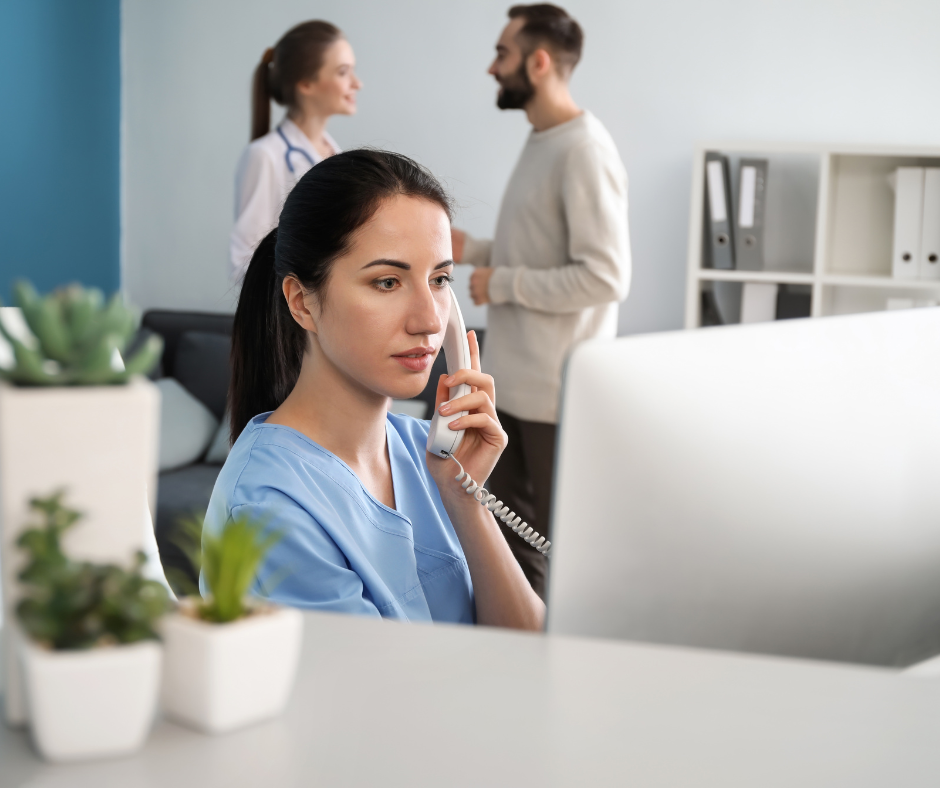 coronis health fqhc healthcare worker talking on phone at computer