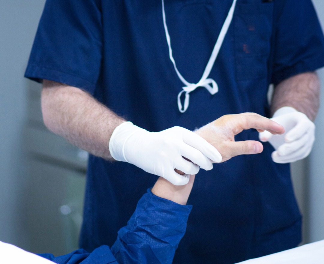 coronis health orthopedist examining a patient's fingers and joints