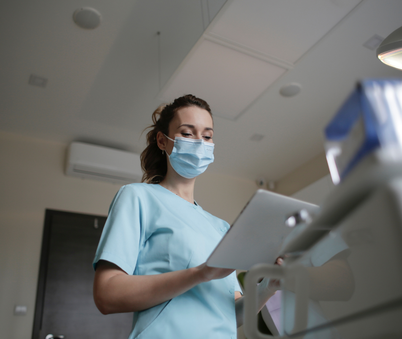 coronis health healthcare worker with mask filling out document