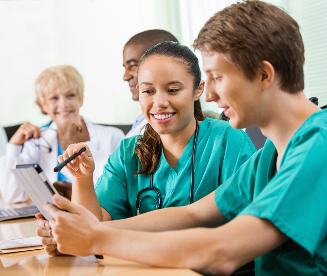 two medical workers discussing bpo on tablet